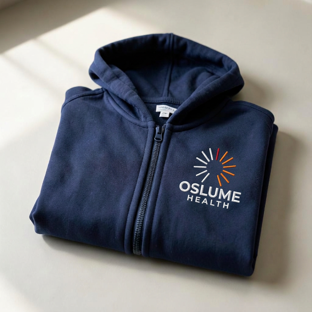 Folded navy Oslume Health zip hoodie with embroidered logo